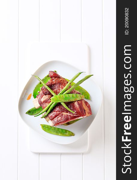 Smoked pork ribs with stir-fried string beans and snow peas