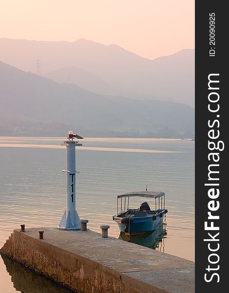 Blue fishing boat at the dock in sunset, HK, China