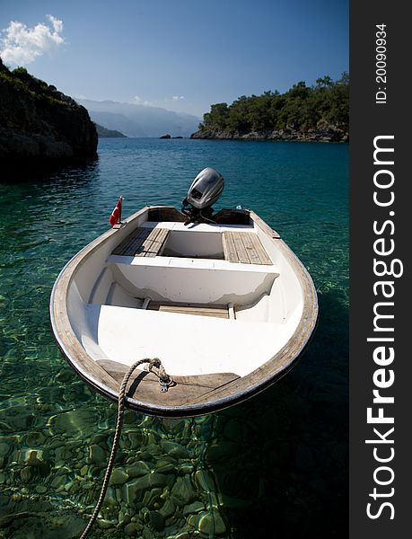 Boat on a remote beach with clear water. Boat on a remote beach with clear water