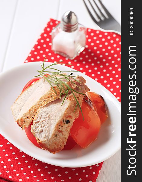 Slices of marinated chicken breast and tomato