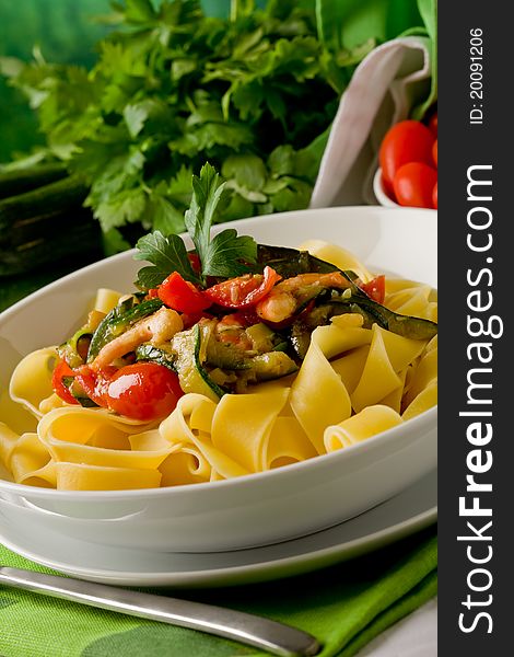 Photo of delicious italian pasta with zucchini and shrimps. Photo of delicious italian pasta with zucchini and shrimps