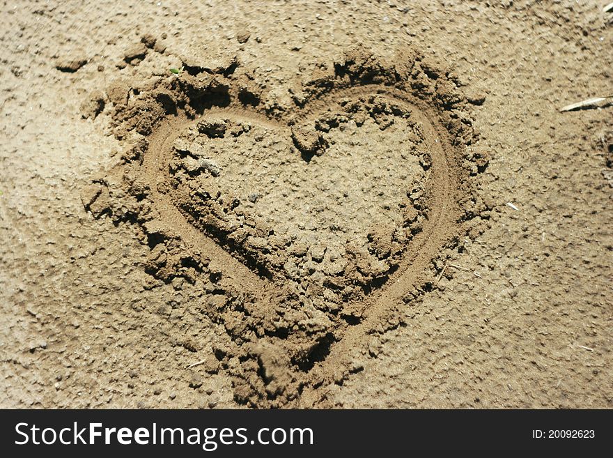 A heart shape drawn in the sand