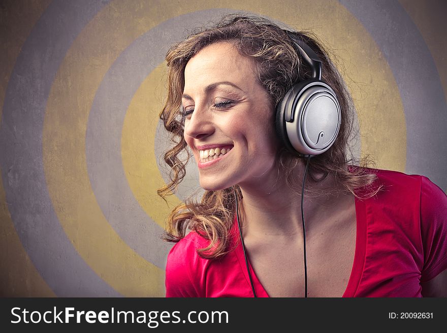 Smiling beautiful woman listening to music. Smiling beautiful woman listening to music