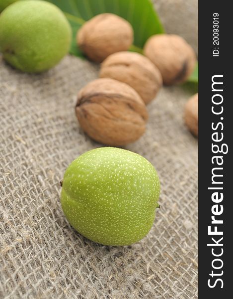 Walnuts with leaves on a background of rough cloth