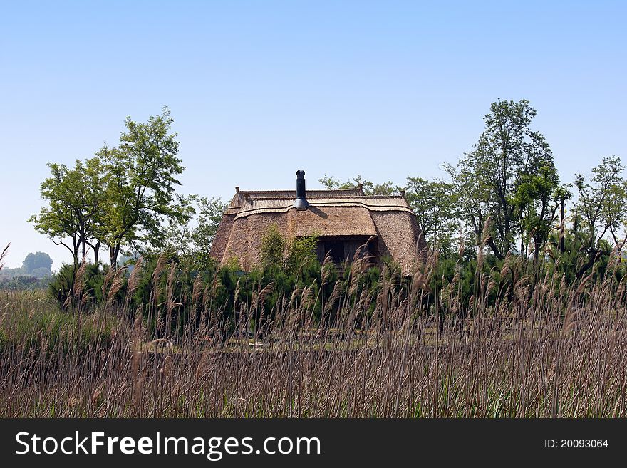 An old fishing hut with a roof of reed in the mediterranean area