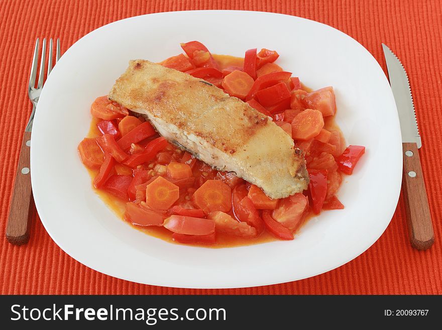 Fried flounder with vegetables on a plate