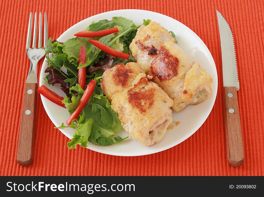 Rolls of turkey with salad on a plate