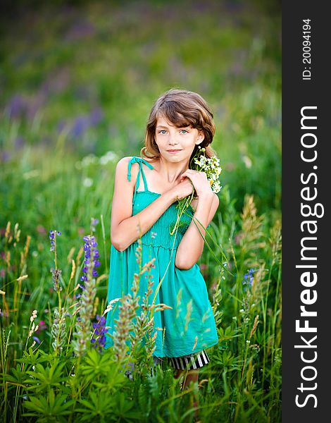 Little girl in the field with flowers. Little girl in the field with flowers