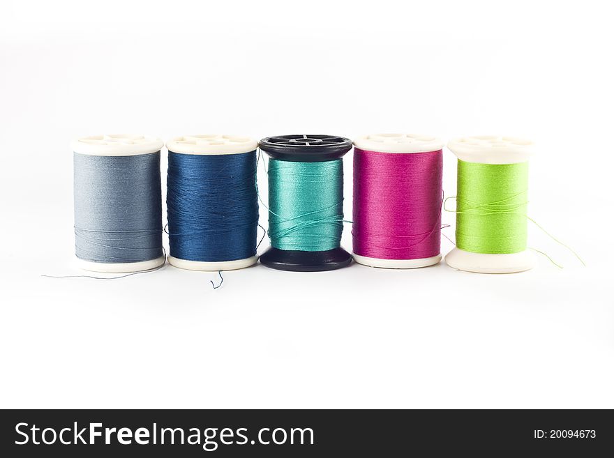 Threads in spools isolated in white background