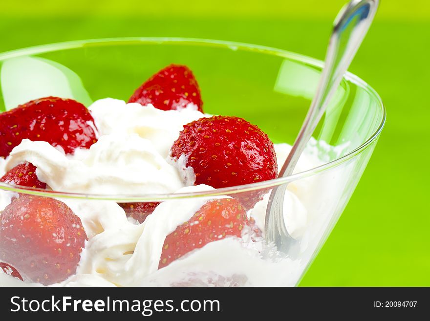 Glass cup with fresh strawberry and cream