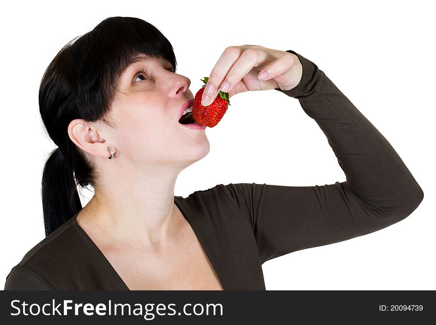 The girl eats a strawberry isolated on the white