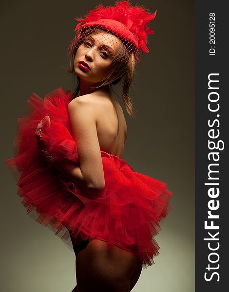 Beautiful woman in red hat and dress. Retro portrait