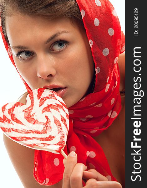 Close-up portrait of young woman with heart shaped lollipop