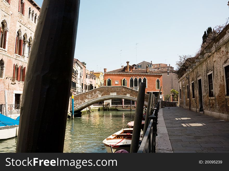 View of venetian canal with red house like a background