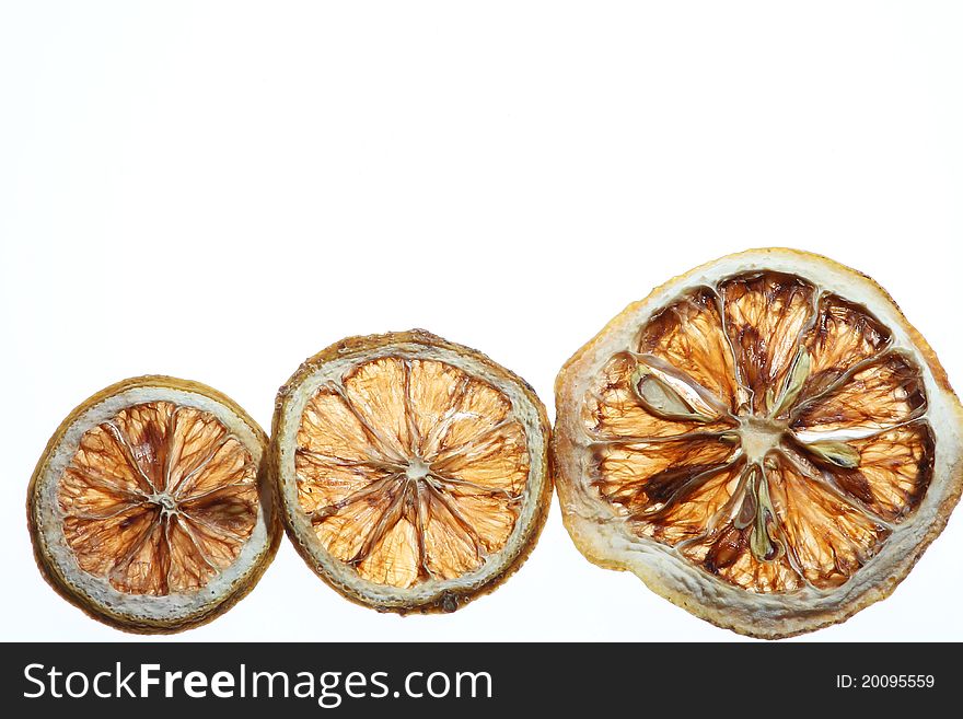 Desicated citrus slice on white background. Desicated citrus slice on white background