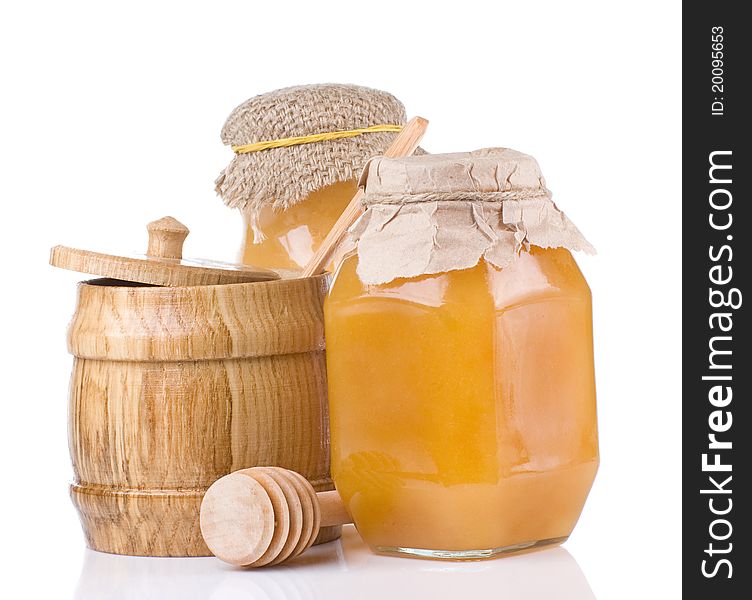Jars And Pot Full Of Honey Isolated On White