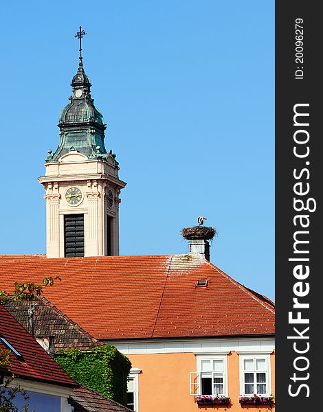 Town Rust / Austria - stork in a nest, church tower
