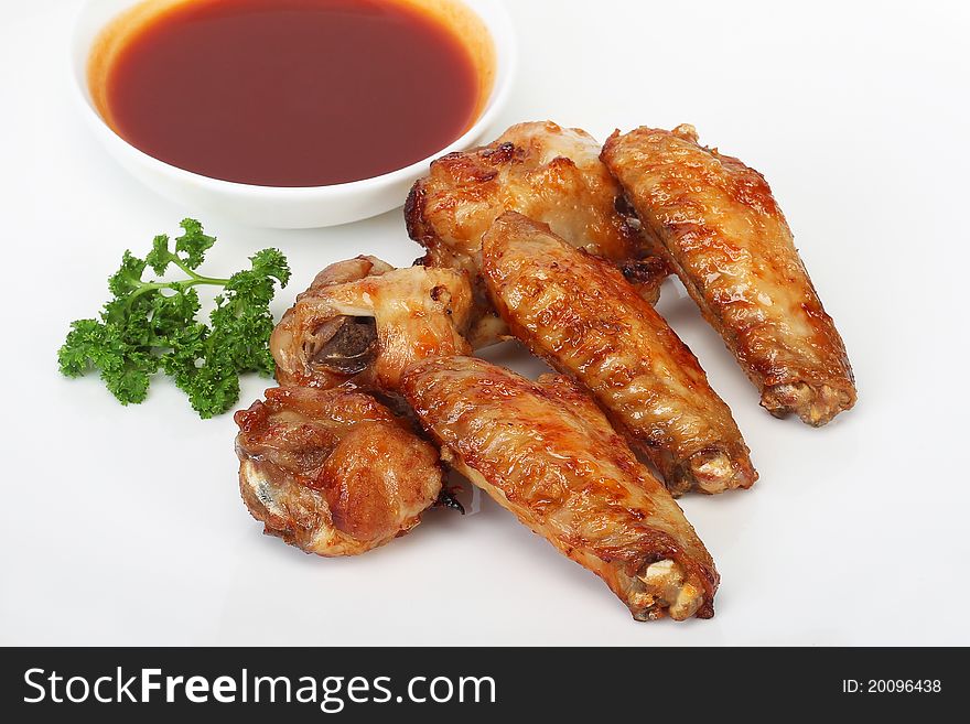 Grilled chicken wings with sauce and parsley