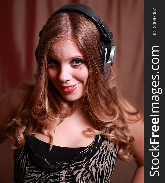 A pretty young woman wearing headphones. A pretty young woman wearing headphones