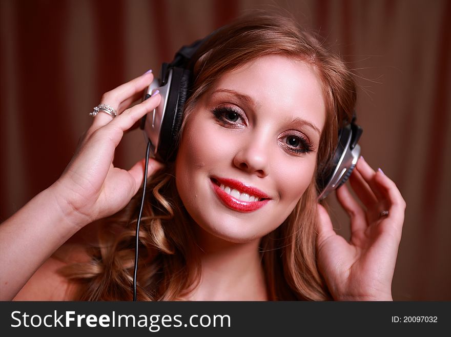 A pretty young woman wearing headphones. A pretty young woman wearing headphones