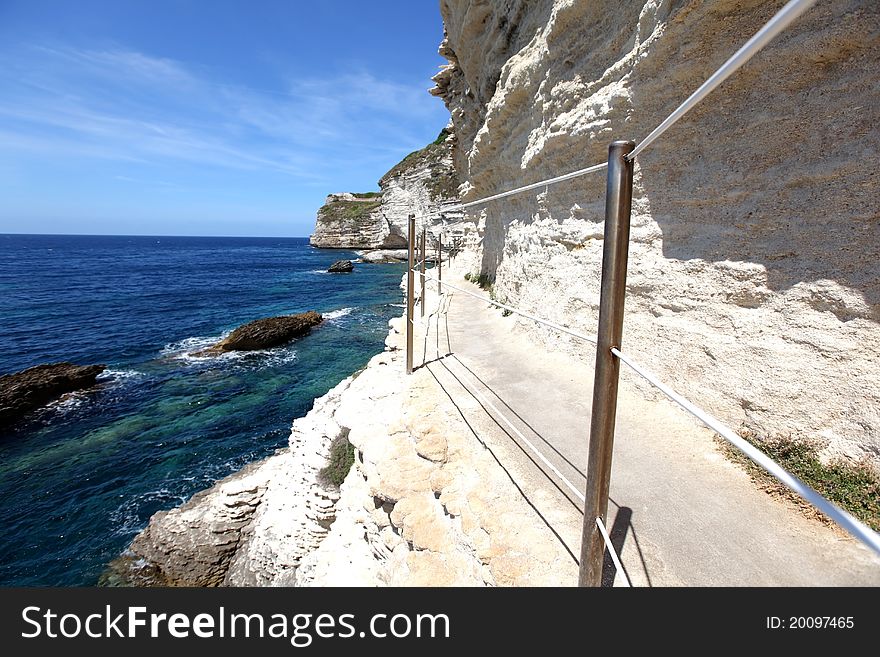 Limestone rock cliffs with a walkway on the island of Corsica