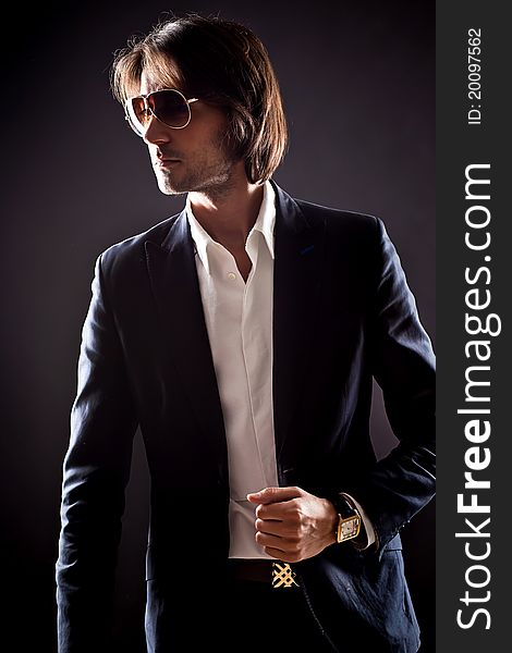 Young serious man in sunglasses and suit. Young serious man in sunglasses and suit