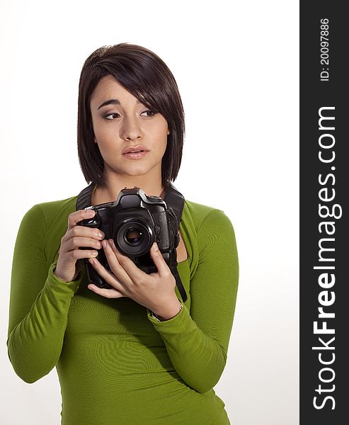 Gorgeous young photographer holding a slr digital camera. Gorgeous young photographer holding a slr digital camera.