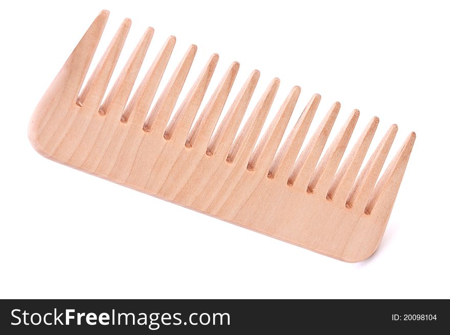 Wooden hairbrush from a birch on a white background close up