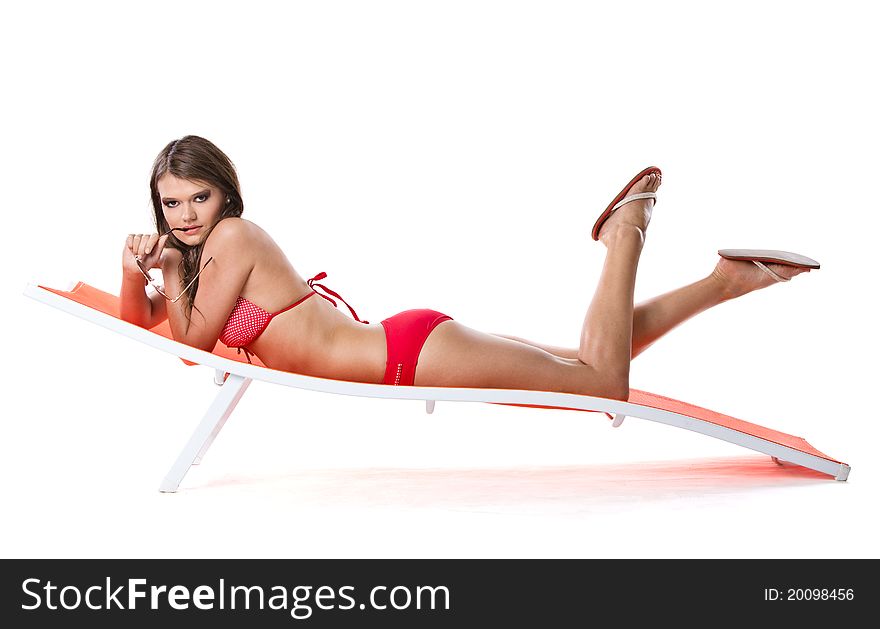 Beautiful young brunette woman relaxing on sunbed, vacation concept shot. Beautiful young brunette woman relaxing on sunbed, vacation concept shot