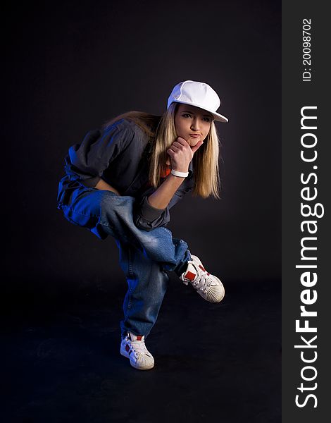 Modern dance, hip hop girl dancer on a black background. Modern dance, hip hop girl dancer on a black background.