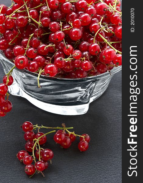 Red currant on the table in a shadow of suburban site