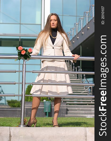 Girl standing in city with roses. Girl standing in city with roses