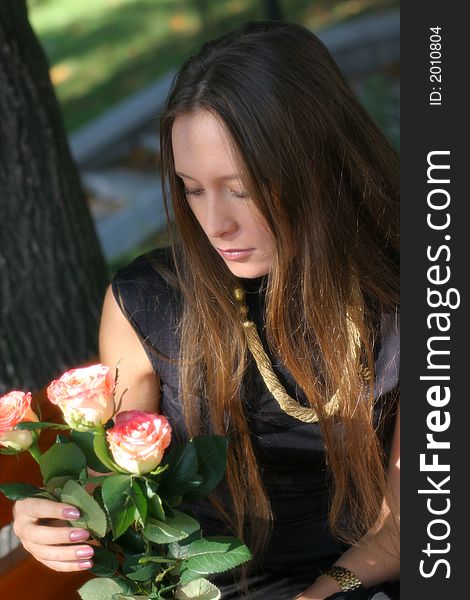 Girl with roses in park