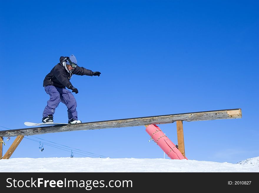 Snowboarder doing a boardslide