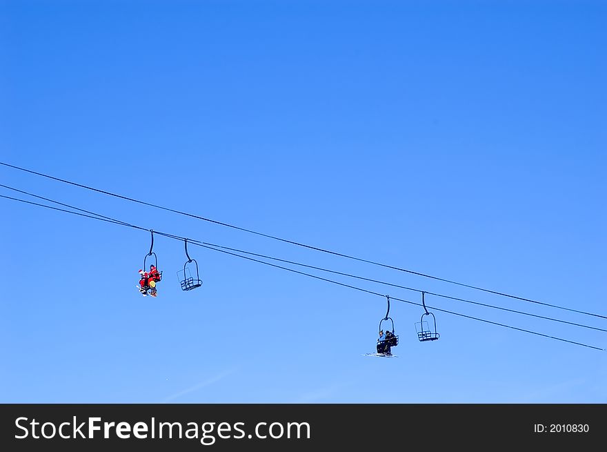 Skiers and snowboarders in a chairlift