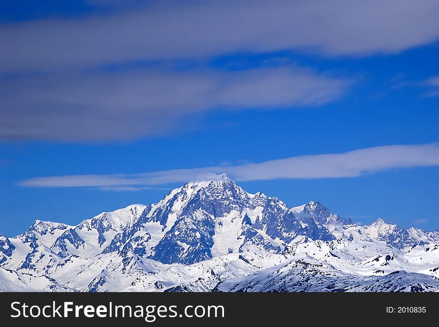 Snowed mountainrange surrounded by clouds. Snowed mountainrange surrounded by clouds