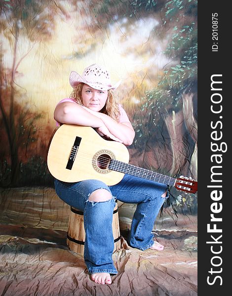 A country woman and her acoustic guitar. A country woman and her acoustic guitar.