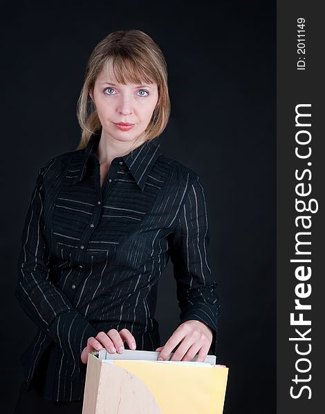 A pretty blond woman sorting through folders in a wooden box