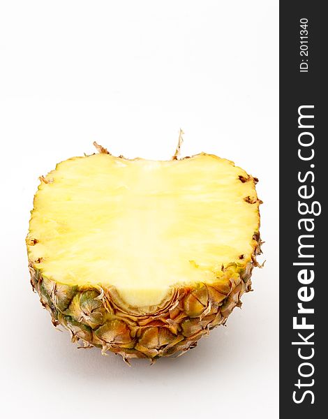 Pineapple cut in half, missing stem. Pineapple cut in half, missing stem