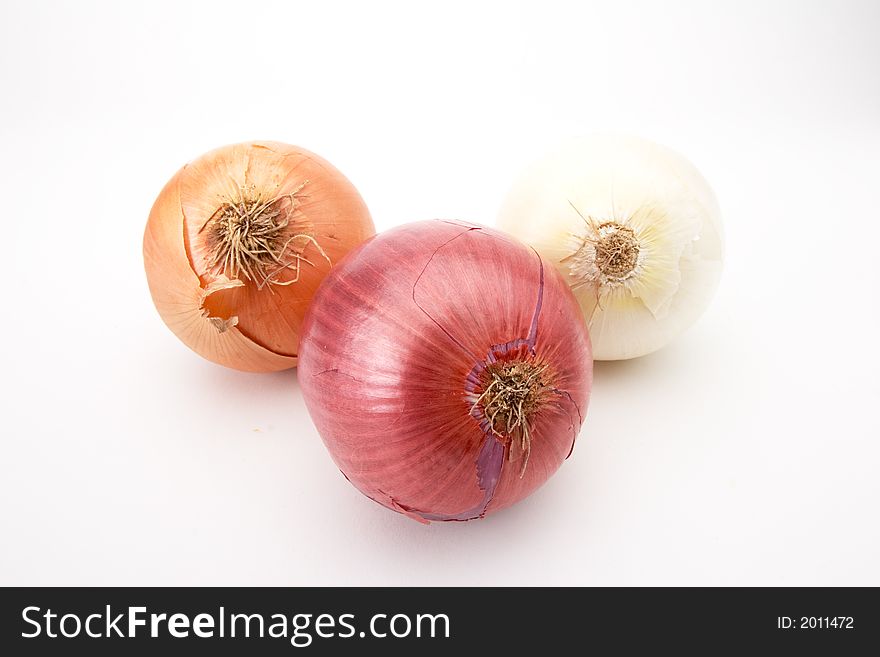 Yellow, red and white onions on white. Yellow, red and white onions on white