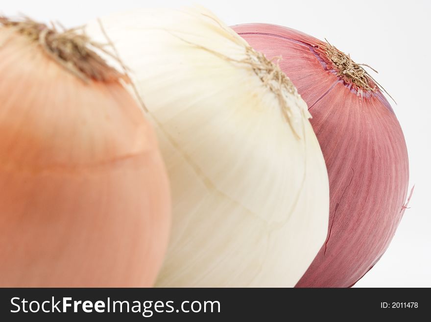 Three onions, close up, shallow depth of field, red onion in focus