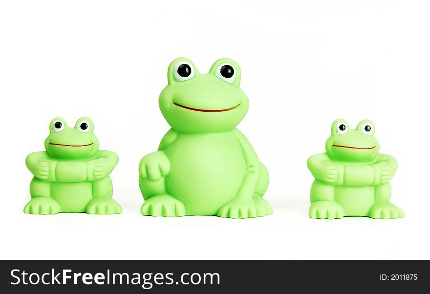 Green plastic toy frogs isolated on white background. Green plastic toy frogs isolated on white background