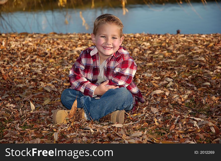 A boy in red at the lake