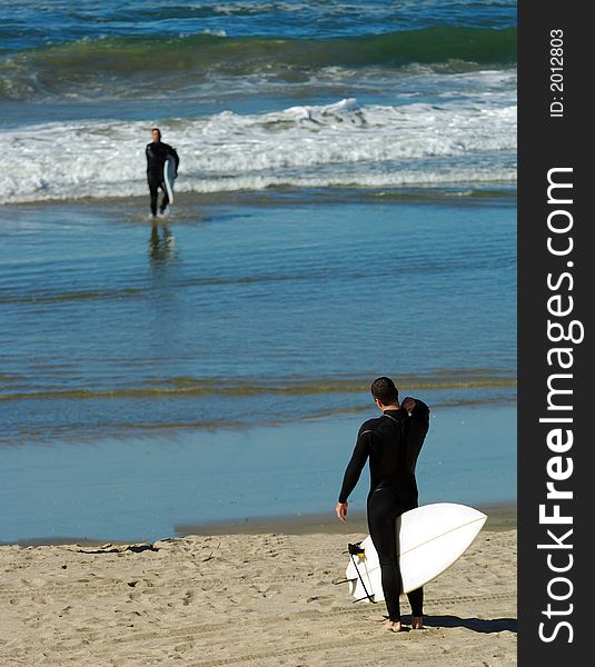 Surfer Adjusts Wetsuit On California Beach. Surfer Adjusts Wetsuit On California Beach