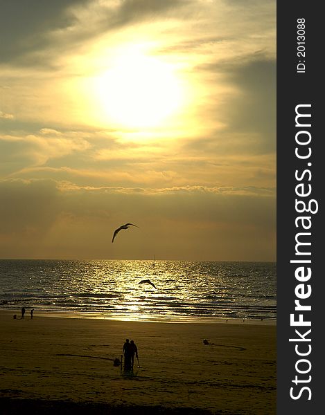 Sea sunset with people on the beach