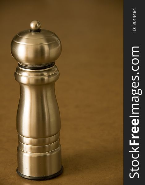 Pepper mill sitting on a bworn kitchen counter