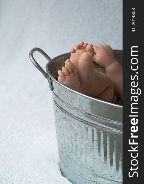 Image of baby feet peeking out over the side of a galvanized tub