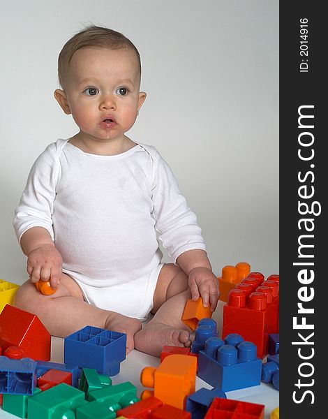 Image of cute baby playing with colorful building blocks. Image of cute baby playing with colorful building blocks