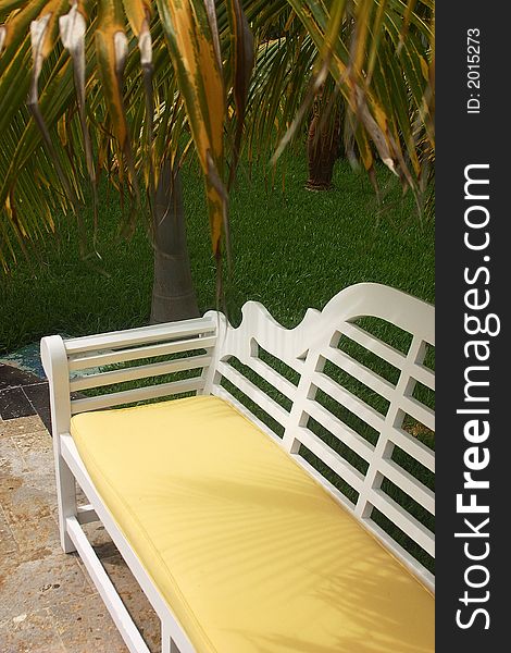 White bank or bench in a hotelgarden at the Riviera maya. White bank or bench in a hotelgarden at the Riviera maya