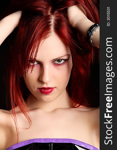 Closeup of a young redhead woman holding up her hair. Closeup of a young redhead woman holding up her hair